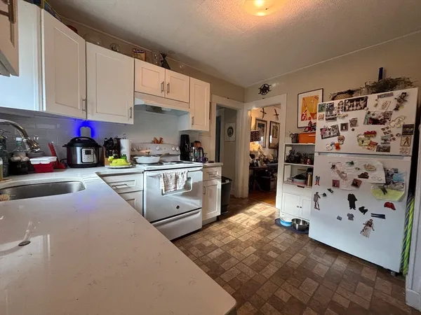a kitchen that has cabinets a sink and a stove top oven