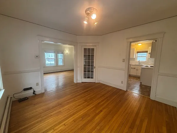 wooden floor in an empty room with a window