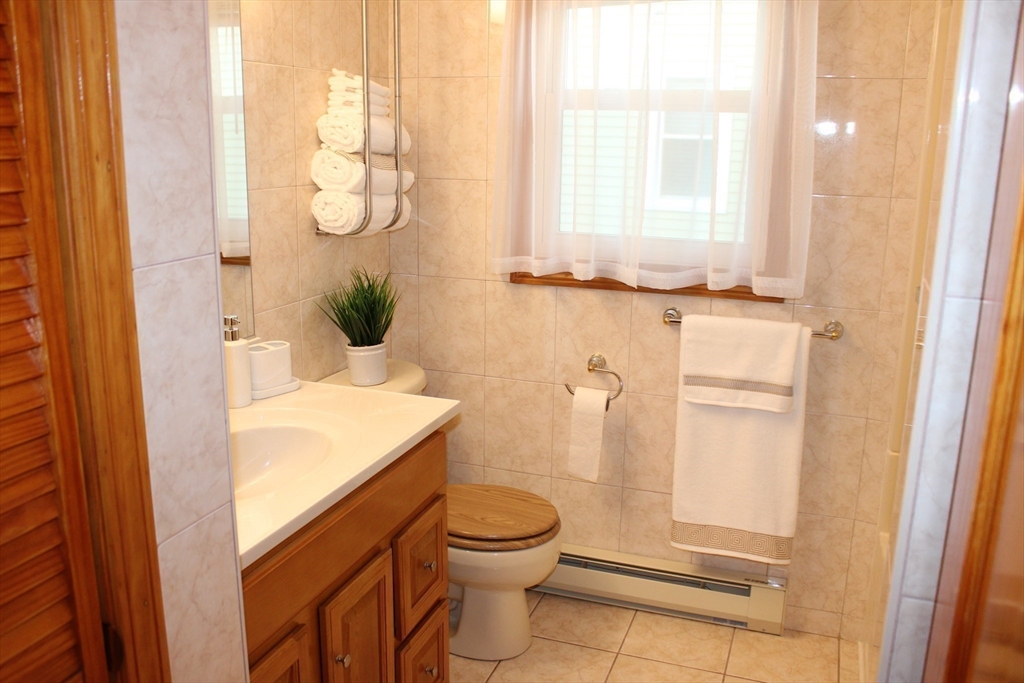 28 State Street Chicopee, MA 01013 - Photo 19 of 25 a bathroom with a granite countertop sink toilet and shower