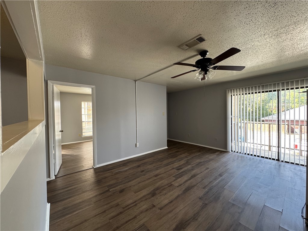 1008 Autumn Circle, Unit A College Station, TX 77840 - Photo 1 of 23 wooden floor in an empty room with a window