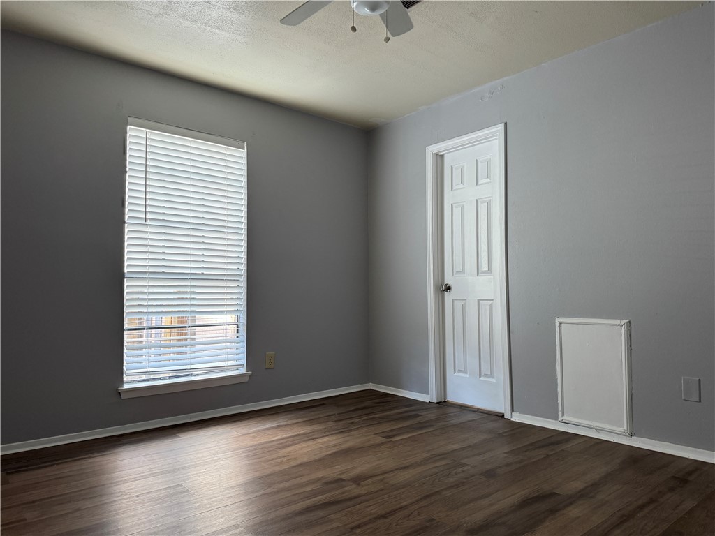 1008 Autumn Circle, Unit A College Station, TX 77840 - Photo 13 of 23 a view of an empty room with wooden floor and a window
