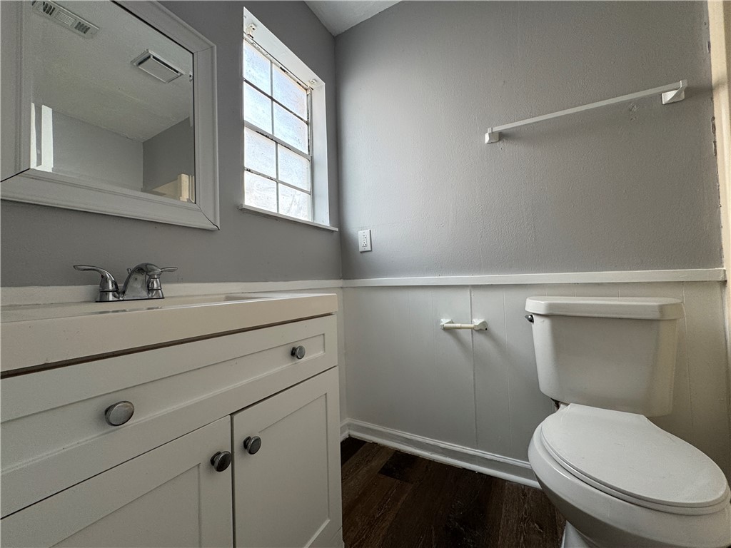 1008 Autumn Circle, Unit A College Station, TX 77840 - Photo 15 of 23 a bathroom with a toilet a sink and mirror