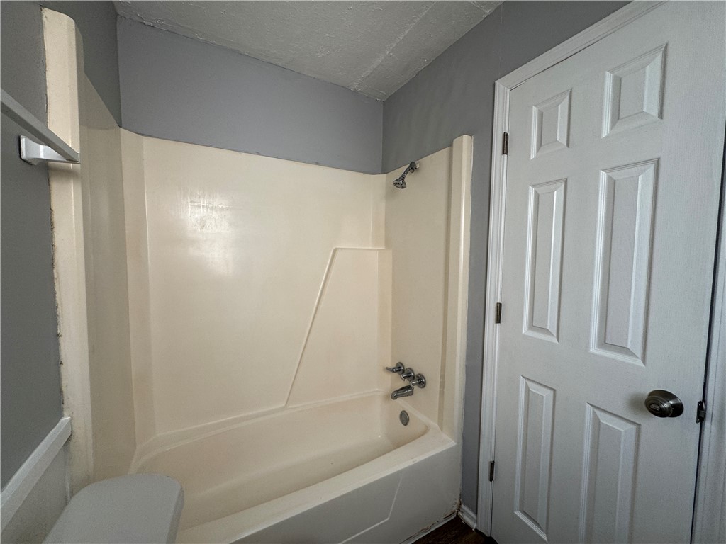 1008 Autumn Circle, Unit A College Station, TX 77840 - Photo 16 of 23 a bathroom with a bathtub and a shower