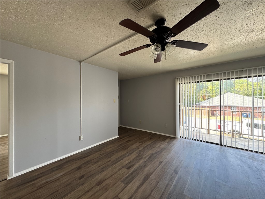 1008 Autumn Circle, Unit A College Station, TX 77840 - Photo 2 of 23 a view of an empty room with wooden floor and a window