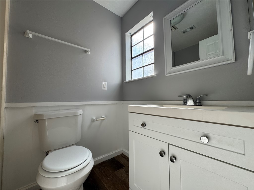 1008 Autumn Circle, Unit A College Station, TX 77840 - Photo 21 of 23 a bathroom with a toilet sink and mirror