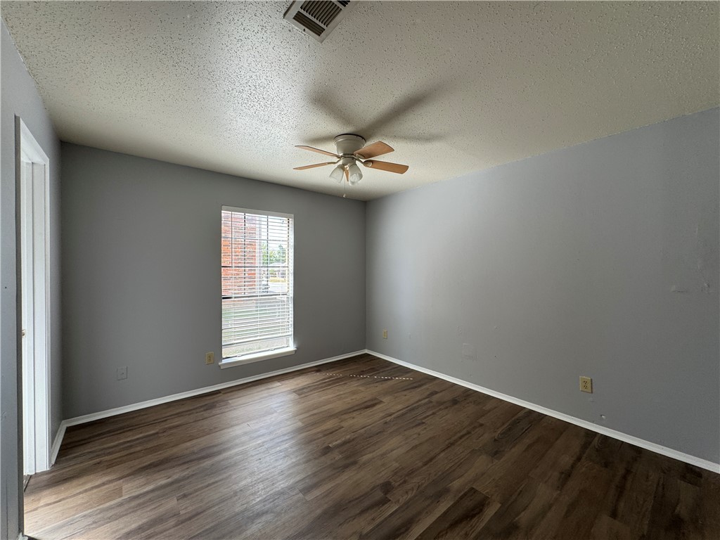 1008 Autumn Circle, Unit A College Station, TX 77840 - Photo 23 of 23 wooden floor in an empty room with a window