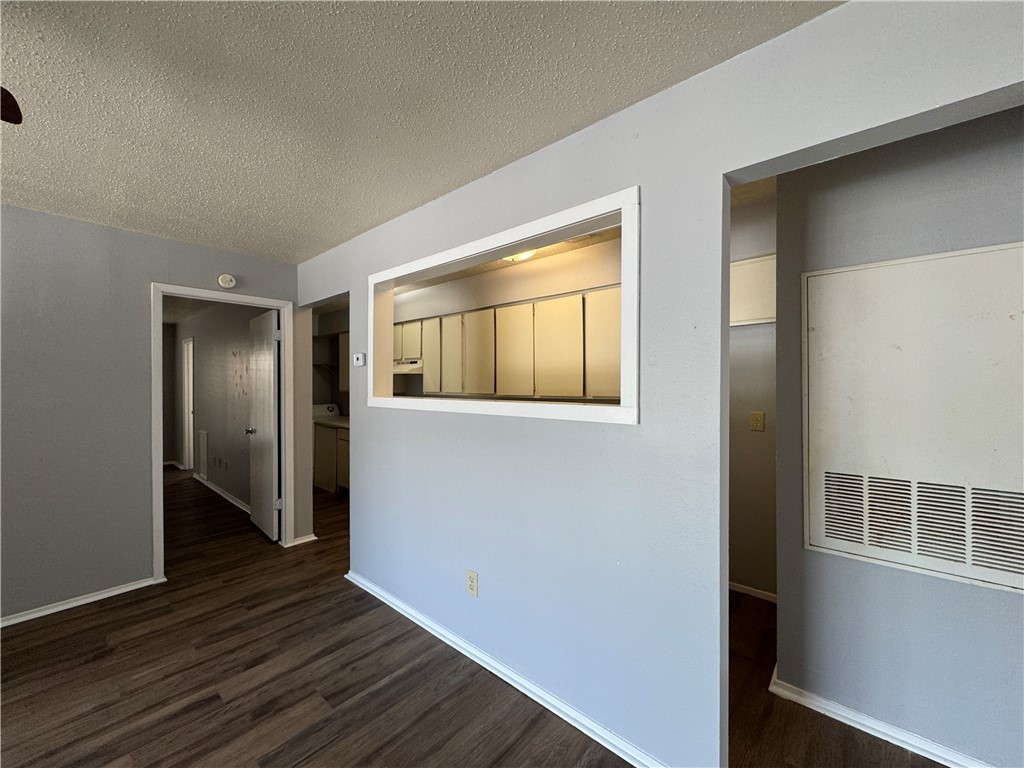 1008 Autumn Circle, Unit A College Station, TX 77840 - Photo 4 of 23 a view of an empty room with wooden floor and a window