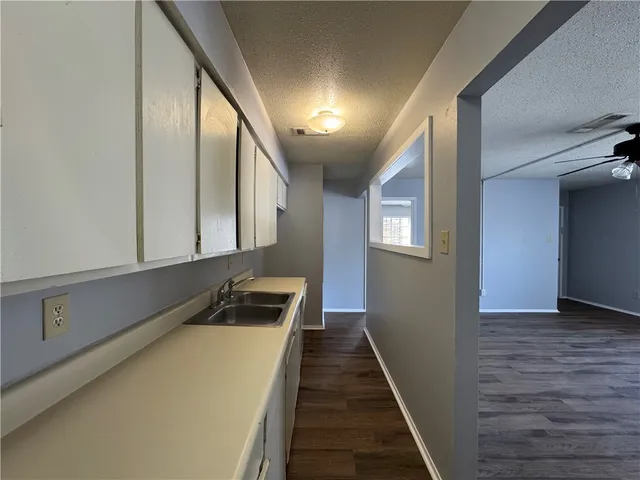 a hallway with front door wooden floor and staircase