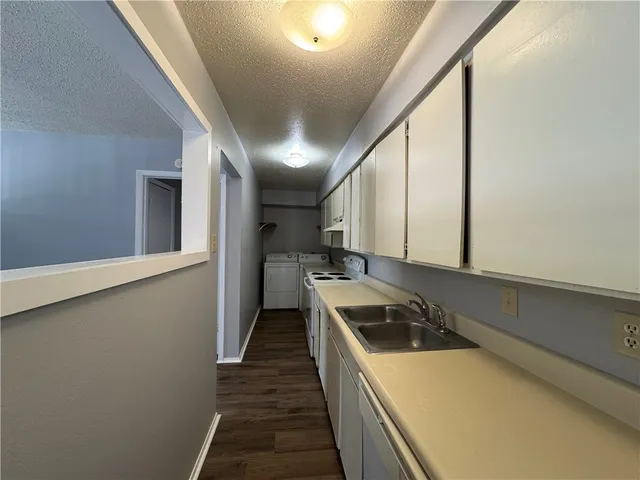 a kitchen with a stove a sink and a refrigerator