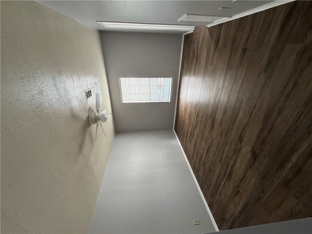 1008 Autumn Circle, Unit A College Station, TX 77840 - Photo 9 of 23 an empty room with wooden floor and windows
