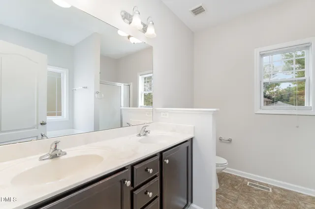 a bathroom with a sink vanity and a mirror