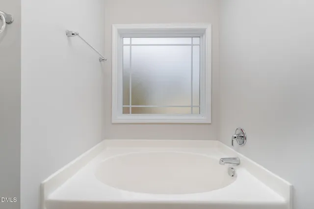 a white bath tub sitting in a bathroom