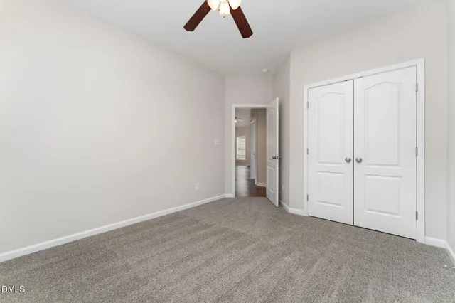 an empty room with ceiling fan