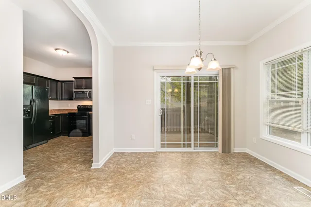 a view of a room with kitchen and windows
