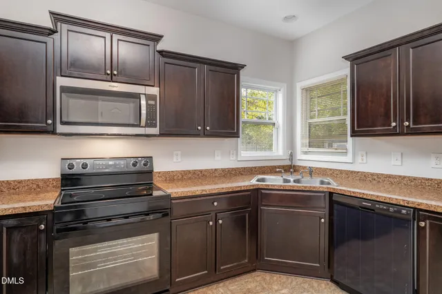 a kitchen with a sink stove and microwave