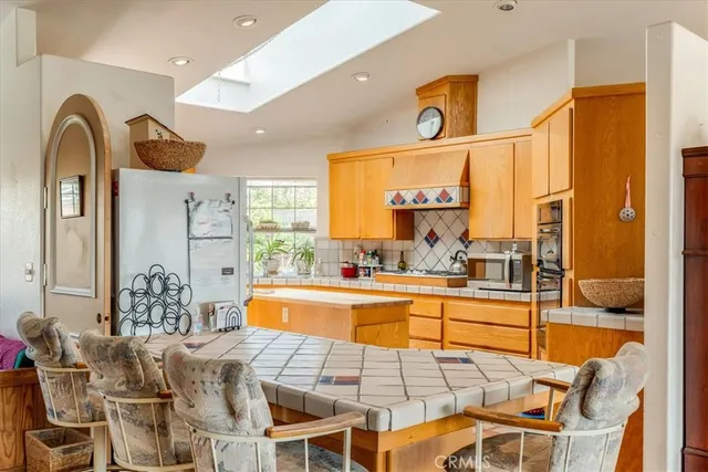 a kitchen that has a lot of cabinets a sink and a stove in it