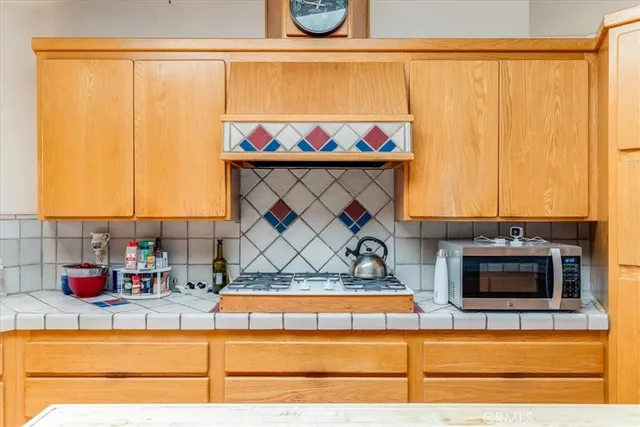 a kitchen with stainless steel appliances granite countertop a sink and a stove top oven