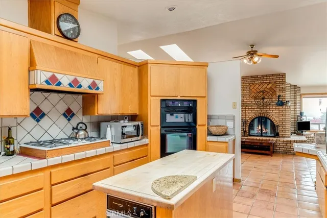 a kitchen with stainless steel appliances granite countertop a sink and a stove top oven