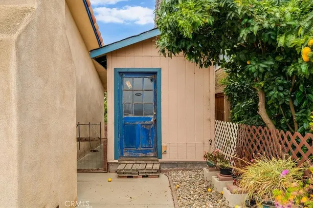 a view of a patio with plants and table and chairs
