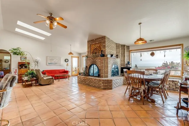 a living room with furniture a dining table and a chandelier