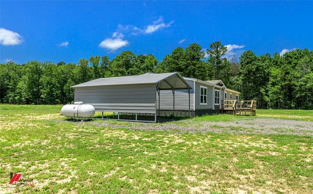 810 Chalybeate Springs Road Plain Dealing, LA 71064 - Photo 3 of 36 a house view with a garden space