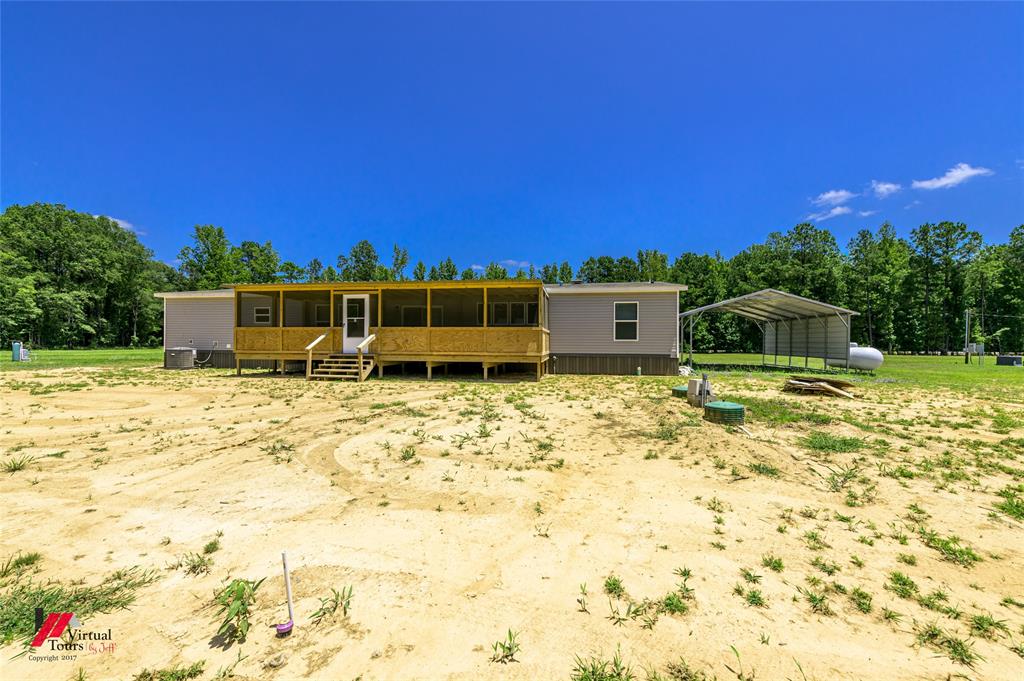 810 Chalybeate Springs Road Plain Dealing, LA 71064 - Photo 31 of 36 a house view with a swimming pool
