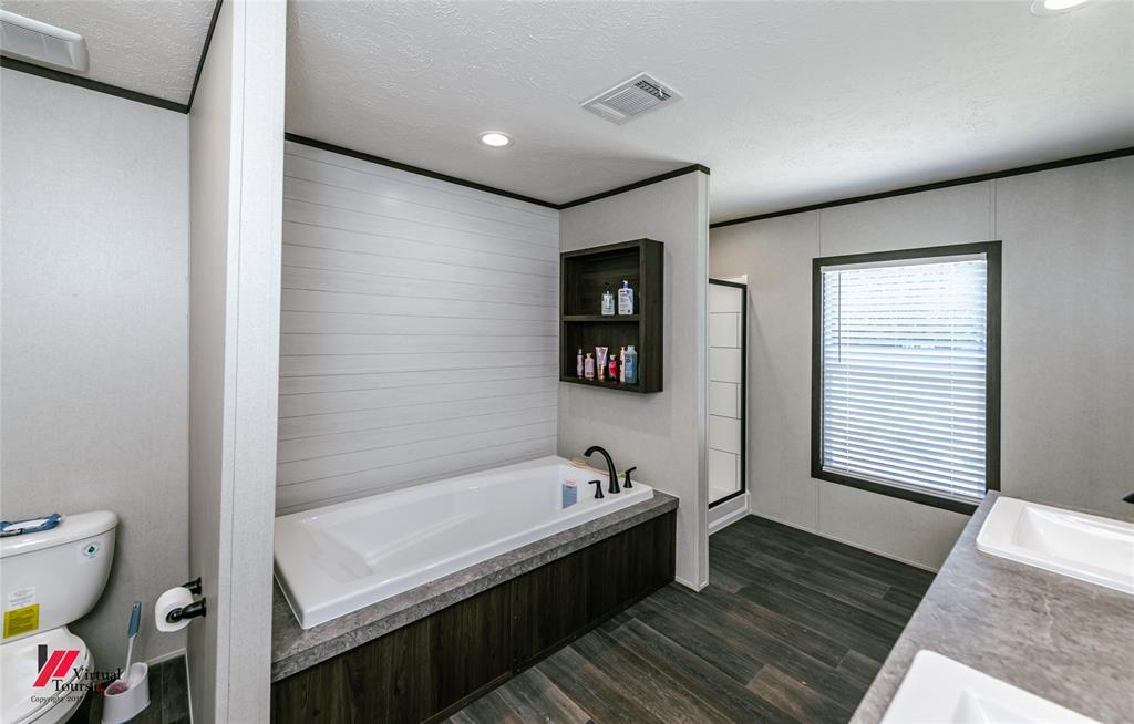 810 Chalybeate Springs Road Plain Dealing, LA 71064 - Photo 8 of 36 a bathroom with a bathtub and a toilet