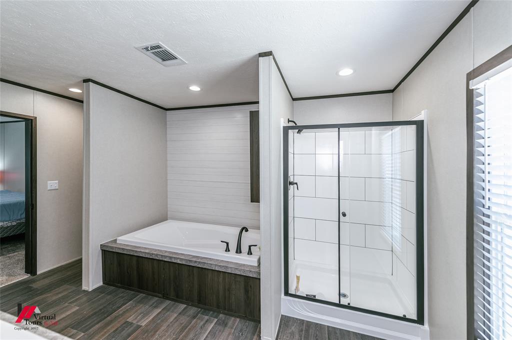 810 Chalybeate Springs Road Plain Dealing, LA 71064 - Photo 9 of 36 a bathroom with a mirror and a shower