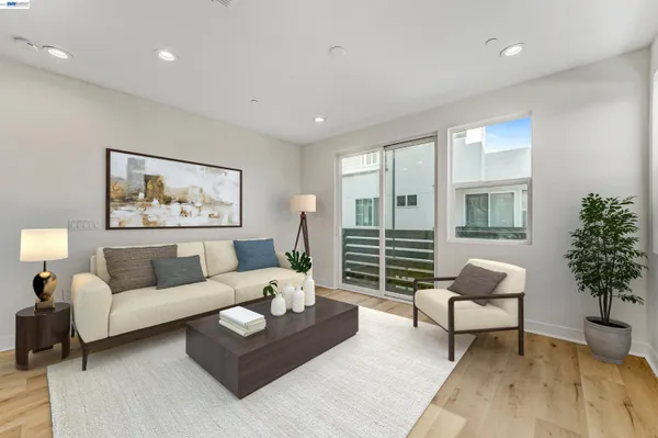 a living room with furniture and a potted plant