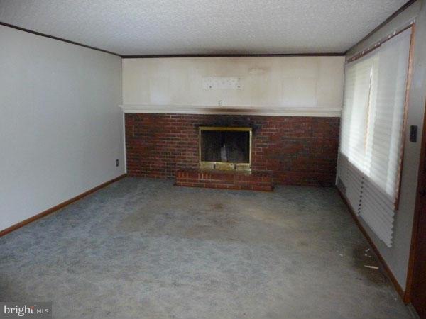 8309 Berkfield Road Baltimore, MD 21237 - Photo 3 of 15 a view of empty room with a fireplace