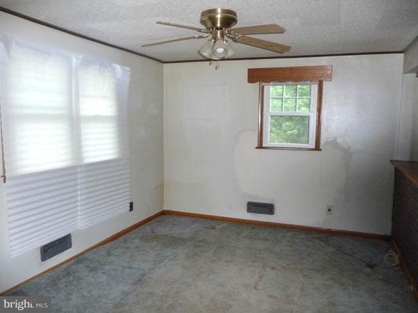 8309 Berkfield Road Baltimore, MD 21237 - Photo 4 of 15 a view of an empty room with a window