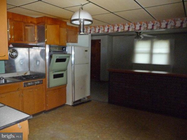 8309 Berkfield Road Baltimore, MD 21237 - Photo 5 of 15 a kitchen with refrigerator and window