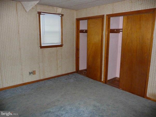 8309 Berkfield Road Baltimore, MD 21237 - Photo 8 of 15 an empty room with windows and closet
