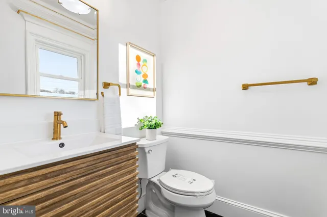 a bathroom with a sink a toilet and mirror