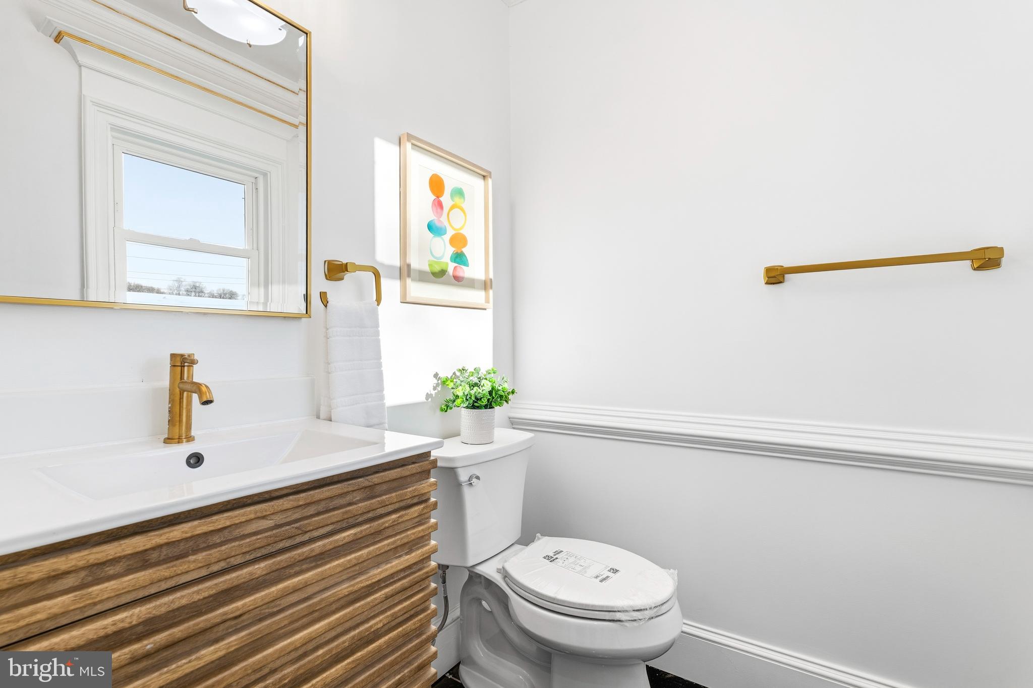 6218 Suitland Road Suitland, MD 20746 - Photo 15 of 52 a bathroom with a sink a toilet and mirror