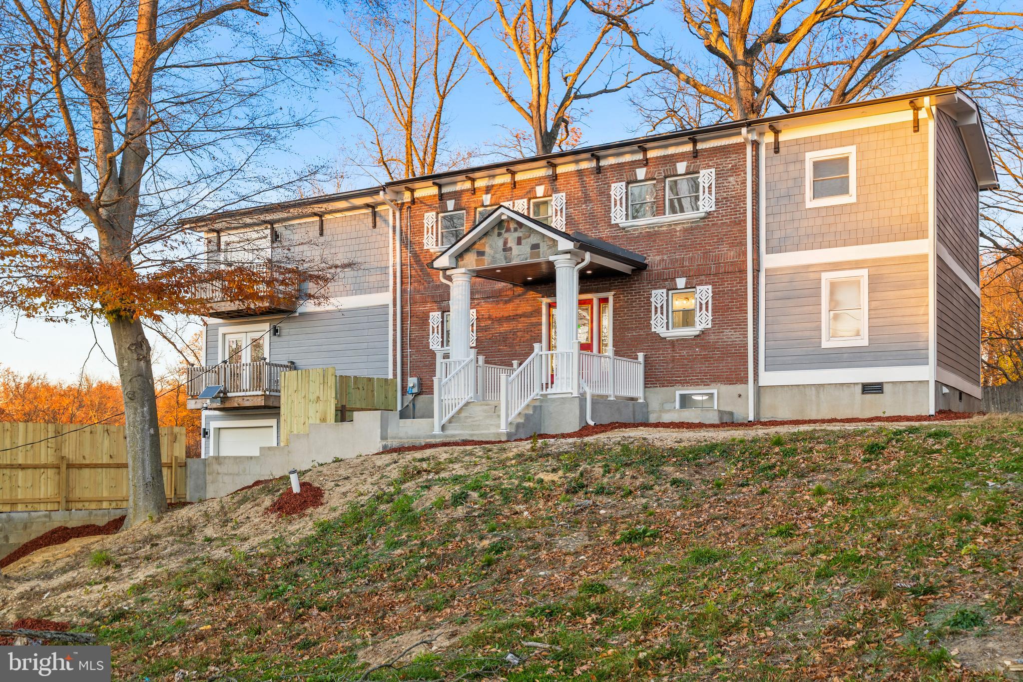6218 Suitland Road Suitland, MD 20746 - Photo 2 of 52 a view of a house with a large tree and wooden fence