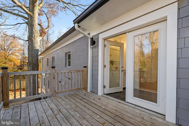 a view of a balcony with wooden floor and fence