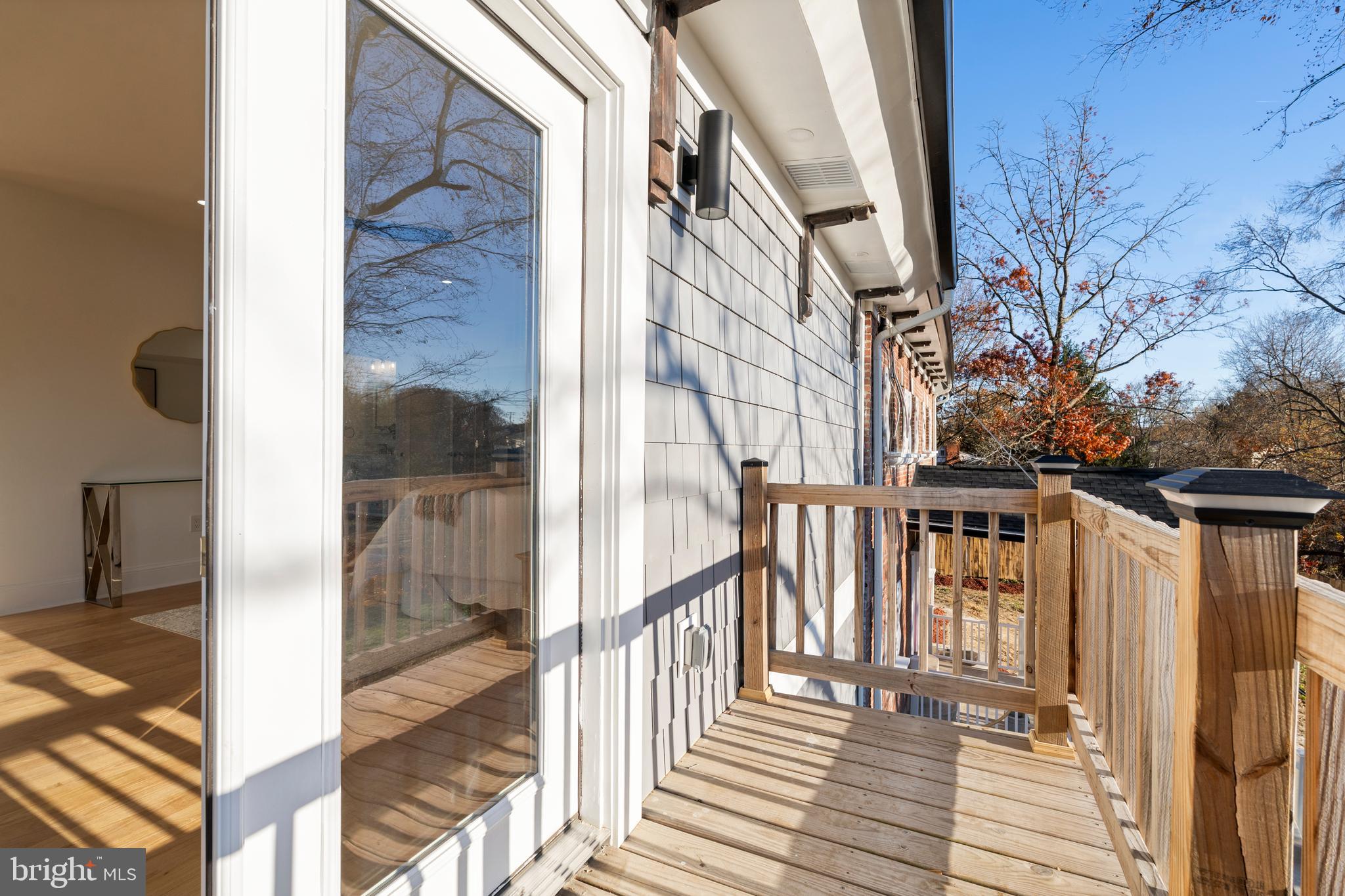 6218 Suitland Road Suitland, MD 20746 - Photo 27 of 52 a view of a balcony with wooden floor and fence