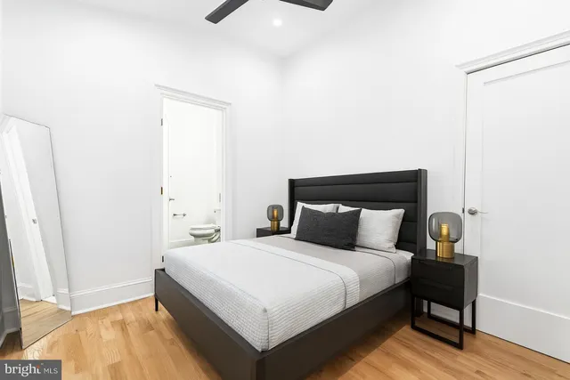 a spacious bedroom with a bed and a potted plant