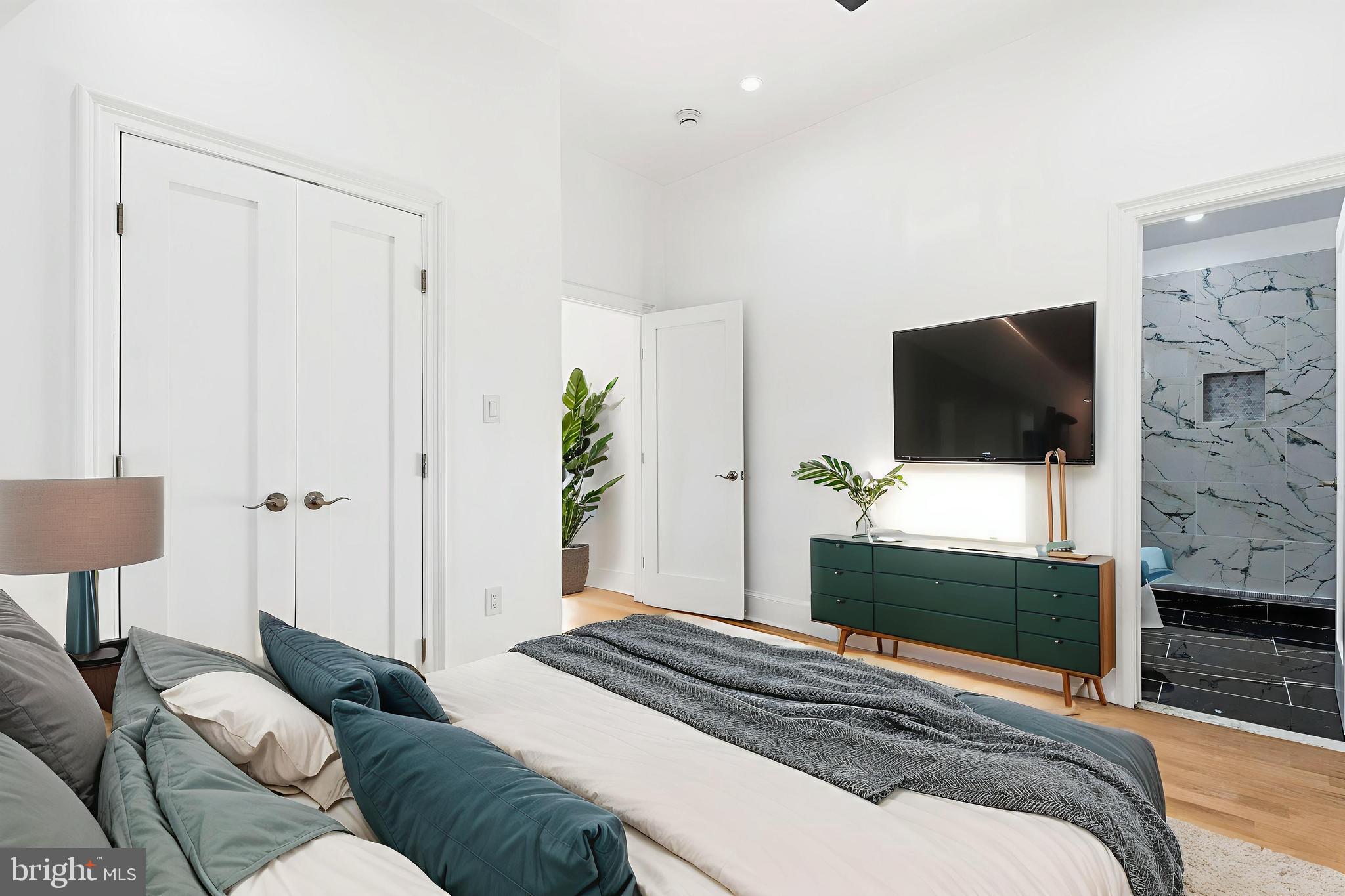 6218 Suitland Road Suitland, MD 20746 - Photo 32 of 52 a bedroom with a bed and a flat screen tv