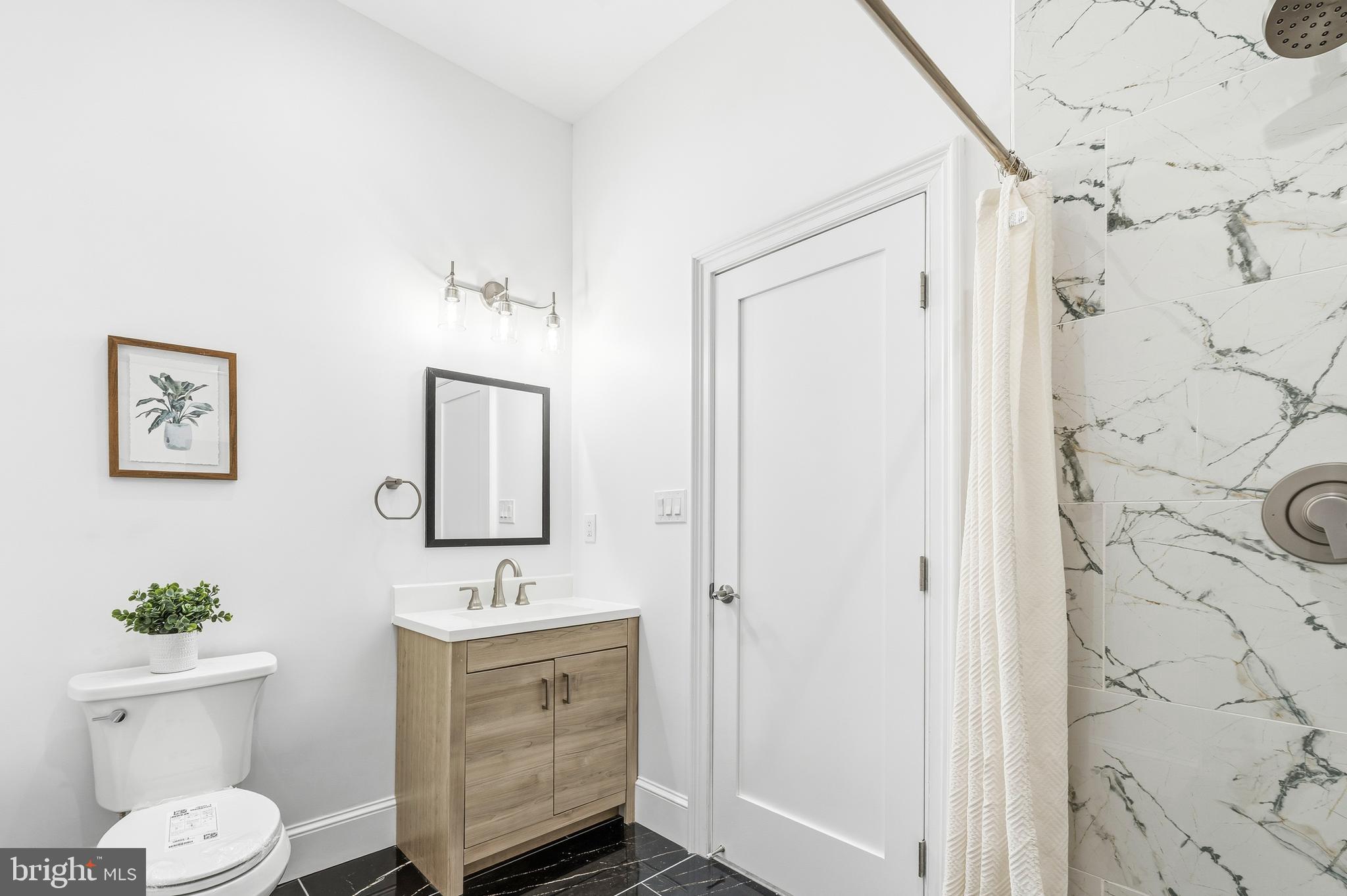 6218 Suitland Road Suitland, MD 20746 - Photo 33 of 52 a bathroom with a sink a toilet and shower
