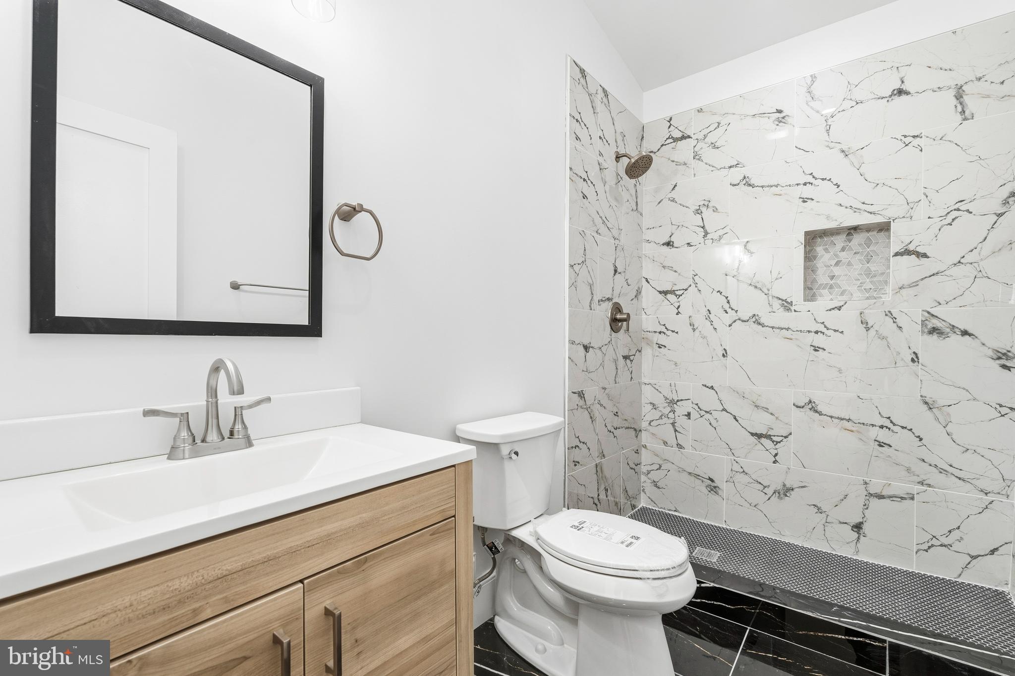6218 Suitland Road Suitland, MD 20746 - Photo 34 of 52 a bathroom with a sink a toilet and shower curtain
