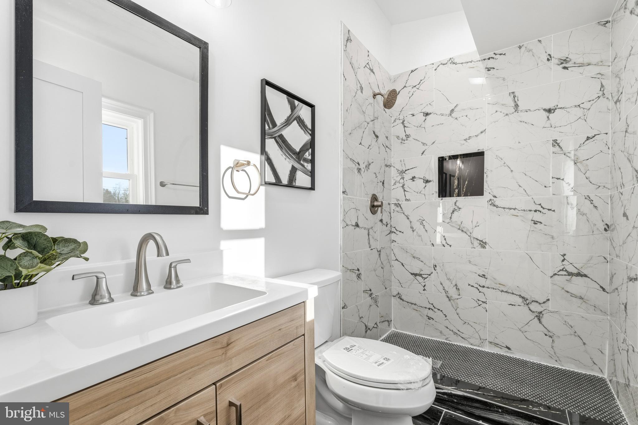 6218 Suitland Road Suitland, MD 20746 - Photo 35 of 52 a bathroom with a sink toilet and shower
