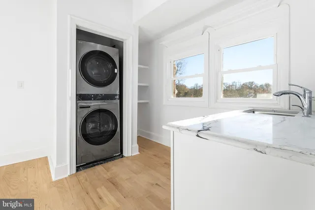 a view of a kitchen with furniture and white cabinets