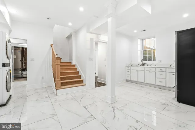 a kitchen with white cabinets and white appliances