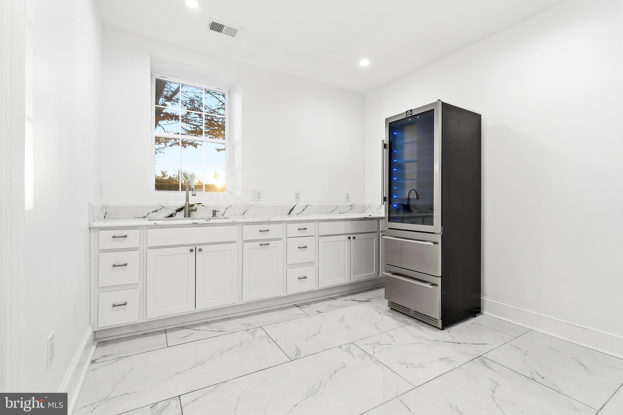 6218 Suitland Road Suitland, MD 20746 - Photo 40 of 52 a kitchen with white cabinets and white appliances