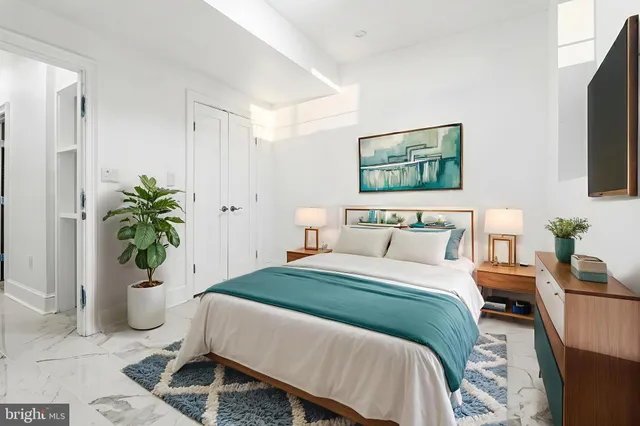 a bathroom with a granite countertop toilet and a sink