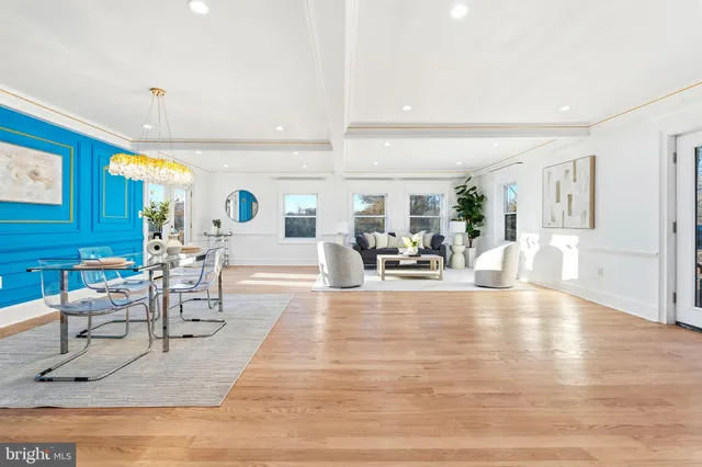 a living room with fireplace furniture and a table