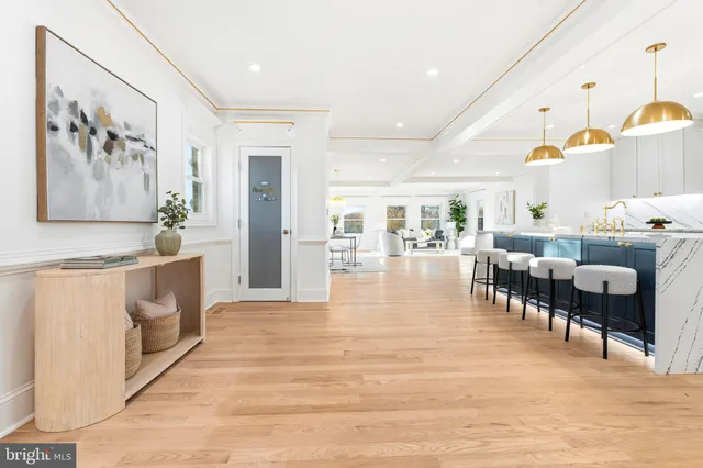 a dining hall with stainless steel appliances granite countertop a stove and a refrigerator