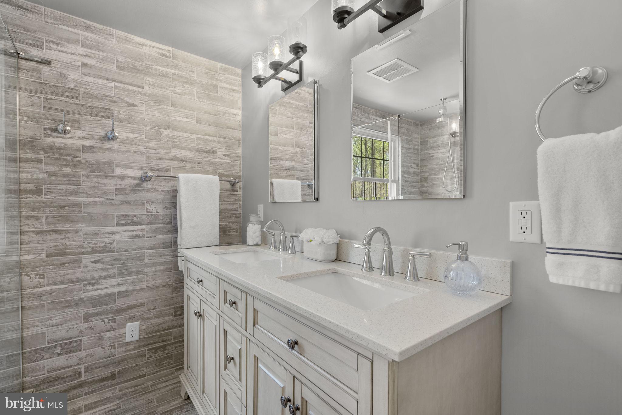 1210 Ashton Road Ashton, MD 20861 - Photo 36 of 71 a bathroom with a sink a vanity and a mirror